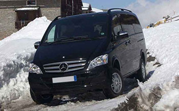Black Mercedes Viano minivan on a snowy mountain road
